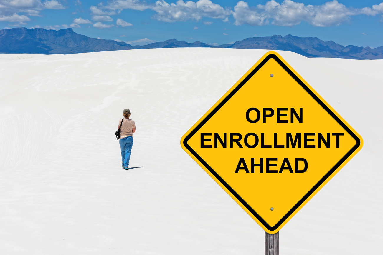 Open Enrollment Ahead sign with person walking in distance
